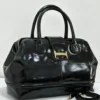 Black patent leather doctor bag with gold buckle logo plate and rolled handles, Nigeria Black patent leather doctor bag with gold buckle logo plate and rolled handles, Nigeria