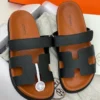 Hermès Chypre Black & Tan Slide Sandals Hermès Chypre Black & Tan Two-Tone H-Cutout Slide Sandals Nigeria