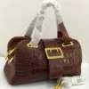 Tomford croc-embossed-brown-leather-boston-bag-gold-buckle-nigeria Tomford Burgundy crocodile-embossed leather Boston bag with gold buckle and double top handles, Nigeria