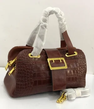 Tomford croc-embossed-brown-leather-boston-bag-gold-buckle-nigeria Tomford Burgundy crocodile-embossed leather Boston bag with gold buckle and double top handles, Nigeria