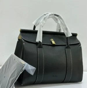 Black structured top handle bag with white contrast stitching gold hardware and detachable shoulder strap Nigeria