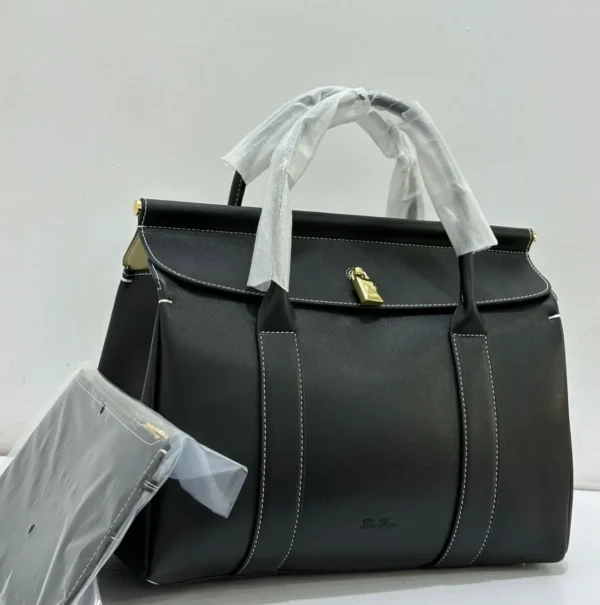 black-structured-top-handle-bag-contrast-stitching-gold-hardware-nigeria Black structured top handle bag with white contrast stitching gold hardware and detachable shoulder strap Nigeria