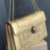 Bvlgari Serpenti Forever chain flap bag gold metallic with black and white snake head clasp Nigeria