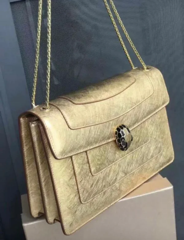 Bvlgari Serpenti Forever chain flap bag gold metallic with black and white snake head clasp Nigeria