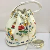 dolce-gabbana-maiolica-bucket-bag-white-floral-baroque-print-gold-padlock-nigeria Dolce and Gabbana Maiolica floral baroque print bucket bag white leather trim gold padlock drawstring top handle Nigeria