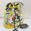 dolce-gabbana-maiolica-bucket-bag-yellow-white-studded-multicolor-beads-gold-padlock-nigeria Dolce and Gabbana Carretto Siciliano print bucket bag red multicolor with gold DG padlock and red drawstring Nigeria