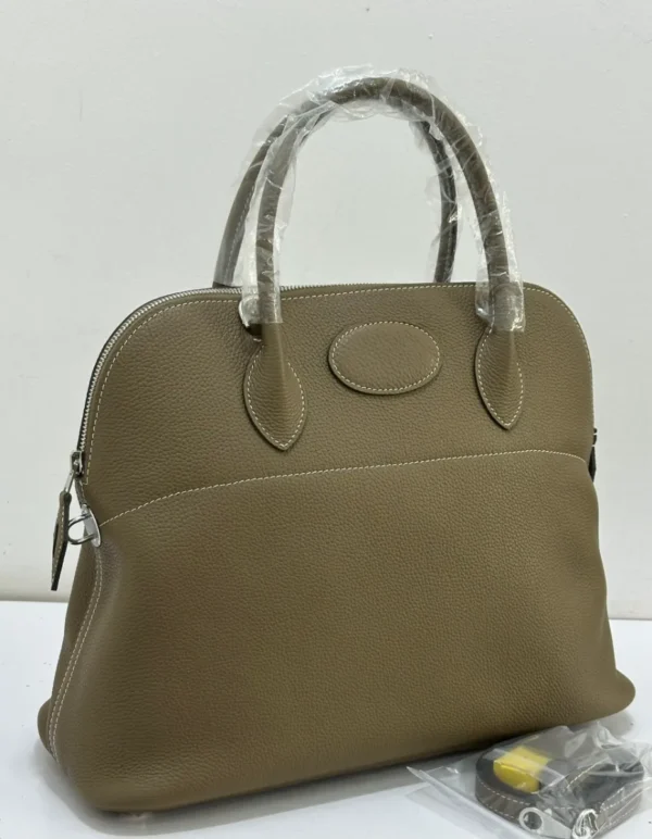 hermes-bolide-style-tote-bag-taupe-etoupe-pebbled-leather-silver-hardware-nigeria Hermes Bolide style tote bag taupe etoupe pebbled leather with oval medallion detail silver hardware and shoulder strap Nigeria