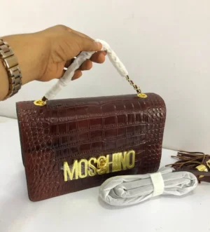 Moschino croc-embossed flap bag deep burgundy brown leather with bold gold MOSCHINO letter logo and chain strap Nigeria