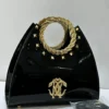 Roberto Cavalli Black patent leather fan-shaped satchel with gold laurel wreath top handle RC logo and pyramid studs Nigeria