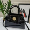 roberto-cavalli-patent-leather-top-handle-bag-black-gold-medallion-studded-nigeria Roberto Cavalli patent leather top handle bag black with gold crest medallion studded detail and crossbody strap Nigeria