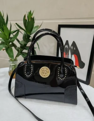 roberto-cavalli-patent-leather-top-handle-bag-black-gold-medallion-studded-nigeria Roberto Cavalli patent leather top handle bag black with gold crest medallion studded detail and crossbody strap Nigeria
