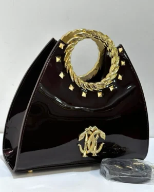Roberto Cavalli wine patent leather fan-shaped satchel with gold laurel wreath top handle RC logo and pyramid studs Nigeria