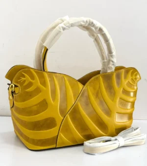 Sculptural leaf embossed leather tote bag yellow mustard with arc top handles and gold hardware Nigeria