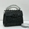 Valentino Garavani VSling crystal embellished top handle bag black leather with black crystal floral detail and gunmetal VLogo hardware Nigeria