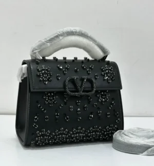 Valentino Garavani VSling crystal embellished top handle bag black leather with black crystal floral detail and gunmetal VLogo hardware Nigeria