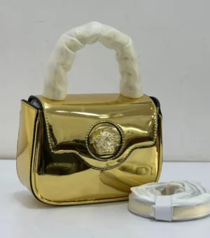 versace-la-medusa-mini-top-handle-bag-gold-metallic-mirror-nigeria Versace La Medusa mini top handle bag gold metallic mirror finish with Medusa medallion clasp and detachable strap Nigeria