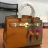 Hermes tan-olive-two-tone- brown structured-leather-tote-turnlock Hermes Tan and olive two-tone structured leather tote with gold turn-lock clasp